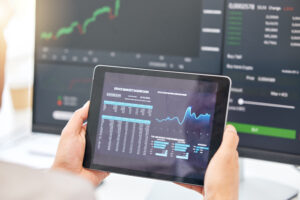 Tablet in hands, graphs and stock market with fintech and trading, investment and financial stats o.