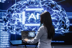 Cover for the "Challenges in AI adoption" blog post. A Programmer analyzing complex AI brain models on laptop, running simulations. Female employee using machine learning software on notebook device to develop artificial intelligence technology
