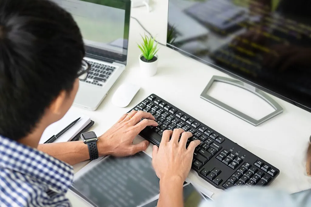 Cover image of the content about Contextualized Coding Assistant, where there is a person coding, facing a computer full of code.