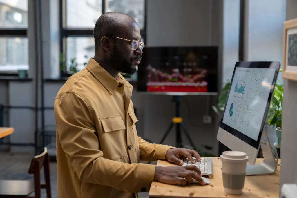 Cover image of the content on Data-Driven Decision-Making, featuring a man in front of a computer analyzing data.