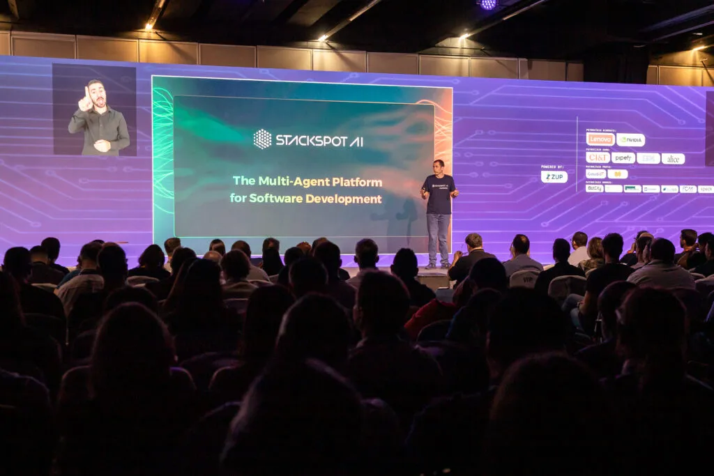 Image of the StartSe AI Day event stage with the screen in the background. On stage is CEO André Palma.